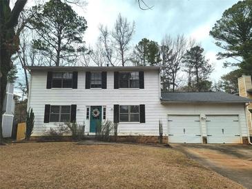 Two-story house with white siding, two-car garage, and manicured lawn at 4488 Ranger Rd, Stone Mountain, GA 30083