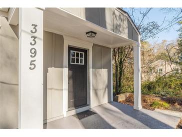 Updated house exterior with a charming front porch and new door at 3395 Lake Valley Nw Rd, Atlanta, GA 30331