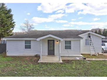 Newly renovated home featuring a charming front porch and updated siding at 840 Forrest St, Roswell, GA 30075
