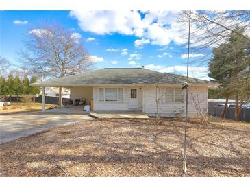 White Ranch style home with mature trees, covered porch and a spacious yard at 830 Forrest St, Roswell, GA 30075
