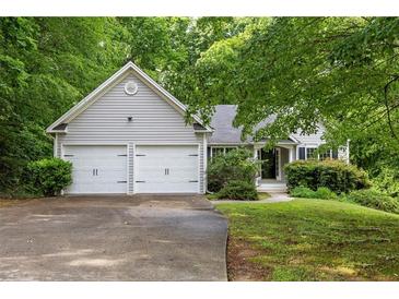 Charming home with a two-car garage, mature trees, and a well-maintained lawn at 245 London Ln, Hiram, GA 30141