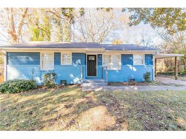 Charming blue house with a well-maintained lawn and carport at 3024 Catalina Dr, Decatur, GA 30032