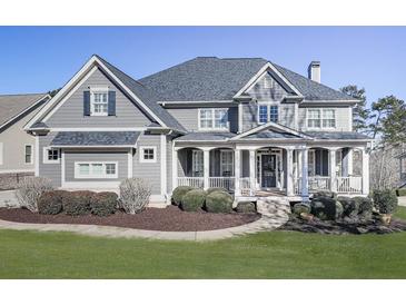 Gray two-story house with white columns and a landscaped yard at 535 Crested Hawk Rdg, Canton, GA 30114