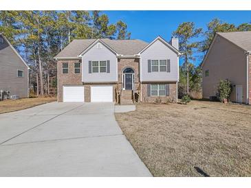 Two-story brick home with attached two-car garage and landscaped yard at 2686 Caleb James Rd, Marietta, GA 30064
