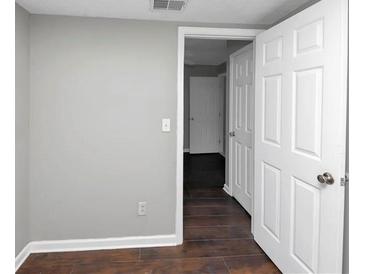 Bright bedroom with hardwood floors and neutral walls at 281 Valley Lake Dr, Stone Mountain, GA 30087