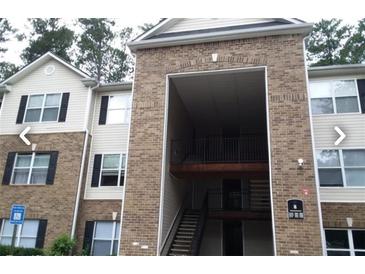 Brick building exterior with balconies and a central staircase at 8101 Par Four Way, Lithonia, GA 30038