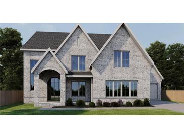 Two-story home with gray brick exterior, arched entryway, and landscaping at 245 River Valley Lot 3 Ct, Atlanta, GA 30328