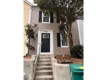 Charming townhome featuring a black front door, two stories, and a well-maintained exterior at 1799 Timber Valley Se Way, Smyrna, GA 30080