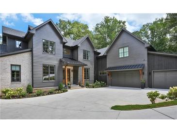 Stunning two-story home featuring a modern design, manicured landscaping, and a spacious driveway at 564 Greystone Trce, Marietta, GA 30068