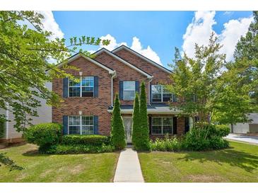 Brick two-story house with a landscaped lawn and walkway at 6684 Crane Ave, Fairburn, GA 30213