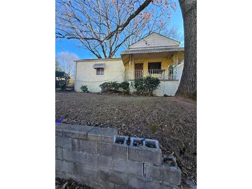 Ranch style home with front porch and mature trees at 1140 Ira Sw St, Atlanta, GA 30310