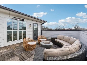 Outdoor patio featuring a fire pit, comfortable seating, and a view of the city skyline at 75 Boulevard Ne # 1, Atlanta, GA 30312