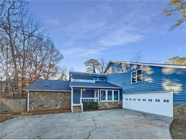 Stunning blue house with stone accents and a two-car garage at 2781 Interlaken Dr, Marietta, GA 30062