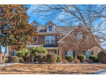 Brick two-story house with landscaping and a large front yard at 1912 Wheat Valley Cir, Conyers, GA 30013