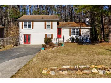 Ranch style home with red door, shutters, and landscaped yard at 4723 N Springs Nw Rd, Kennesaw, GA 30144