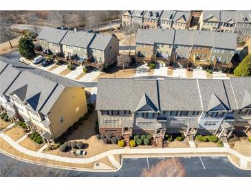 An aerial view showcasing a community of townhomes with ample parking and landscaping at 3898 High Dove Sw Way # 12, Smyrna, GA 30082