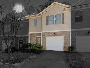 Two-story townhome with attached garage and landscaping at 8471 Douglas Trail, Jonesboro, GA 30236