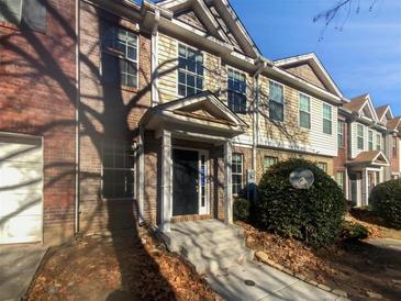 Brick front exterior of townhome with a covered entryway and walkway at 2891 Vining Ridge Ter, Decatur, GA 30034