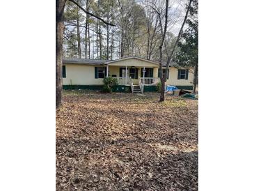 Single-wide mobile home with front porch and large yard at 4197 Hwy 162, Covington, GA 30016