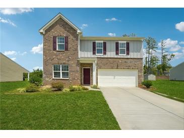 Charming two-story brick home with a well-manicured lawn and a two car garage at 7247 Emma Ct, Douglasville, GA 30134