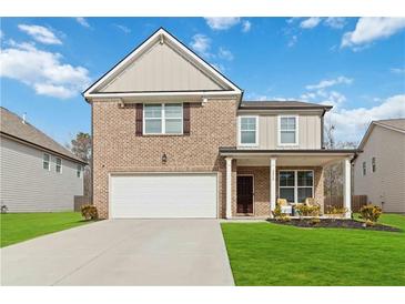 Two-story brick home with a front porch and attached garage at 5010 Ethans Cove Dr, Austell, GA 30106
