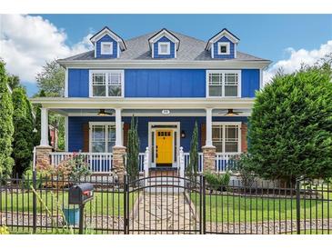 Charming blue two-story home with a welcoming front porch and a bright yellow front door at 930 Custer St, Atlanta, GA 30354