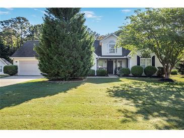 Well-maintained two-story home with lush lawn and mature trees in a peaceful setting at 320 Windermere Dr, Loganville, GA 30052