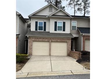 Two-story townhome with two-car garage and brick facade at 5680 Cascade Sw Run, Atlanta, GA 30336