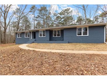 Newly renovated ranch home with gray brick exterior and landscaped yard at 4145 White Oak Dr, Winston, GA 30187