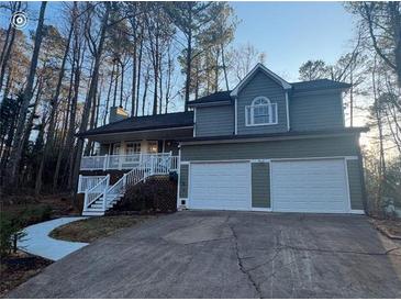 Charming two-story home with attached garage and a inviting front porch and walkway at 54 Cross Branches, Acworth, GA 30101