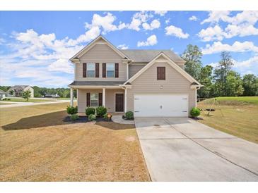 Two-story house with a two-car garage and manicured lawn at 15 Lisa Ct, Covington, GA 30016