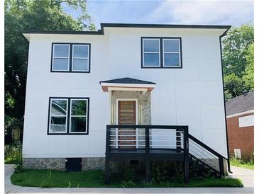 Stunning two-story home features modern design, dark trim, and a deck at 1054 Ira Sw St, Atlanta, GA 30310