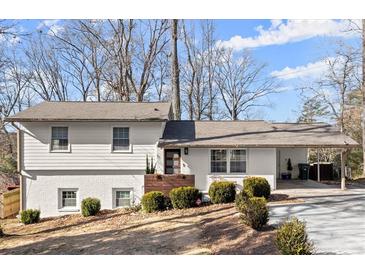 Charming ranch home with white brick exterior, updated landscaping, and a covered carport at 3384 Campbell Se Rd, Smyrna, GA 30080