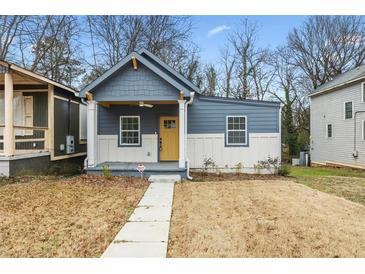 Charming craftsman style home with gray siding and a yellow door at 452 Lindsay Nw St, Atlanta, GA 30314