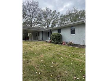 Charming single-story home with a well-maintained lawn and mature trees providing shade at 105 Tranquillity Dr, Villa Rica, GA 30180