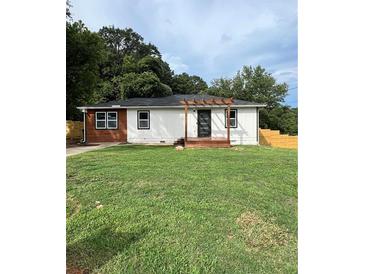 Newly renovated ranch home with modern exterior and a spacious lawn at 1705 Nw Mary George Ave, Atlanta, GA 30318