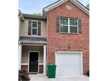 Brick front exterior of townhome with 2-car garage at 1334 Rogers Landing Rd, Lithonia, GA 30058