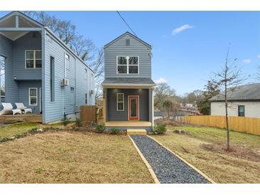 Gray two-story house with a front porch and walkway at 550 Paines Nw Ave, Atlanta, GA 30318