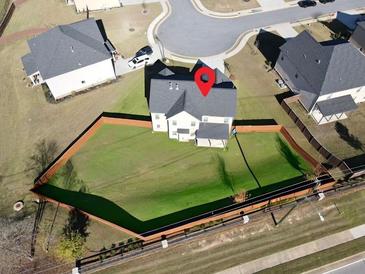 A lovely aerial view of a fenced in back yard and the back of the house at 799 Blue Juniper Cir, Loganville, GA 30052