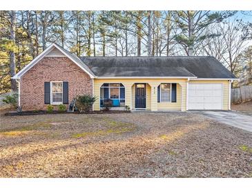 Brick and yellow sided ranch home with attached garage and screened porch at 812 Bartow Ct, Riverdale, GA 30274