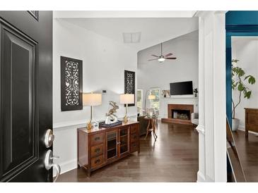 Inviting living room featuring hardwood floors, a fireplace, and a vaulted ceiling with lots of natural light at 1479 Brentwood Dr, Marietta, GA 30062