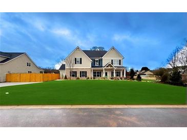 Two-story house with a large green lawn and a wooden fence at 1421 Stephens View Dr, Loganville, GA 30052