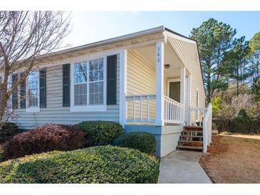 Tan colored house with white porch and landscaping at 366 Oak Harbor Trl, Marietta, GA 30066