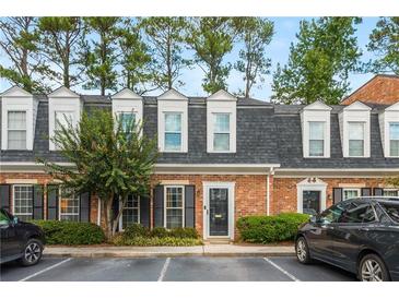 Brick front of charming townhome with mature landscaping and parking at 12 Independence Nw Pl # 12, Atlanta, GA 30318
