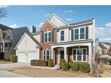 Two-story brick home with a large front yard and attached two-car garage at 3648 Ramsey Close Sw, Atlanta, GA 30331