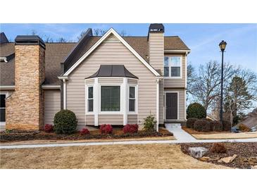 Attractive 2-story townhome with stone accents and landscaping at 1418 Defoors Nw Dr, Atlanta, GA 30318