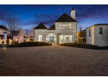 Stunning white two-story home with unique architectural details and landscaped yard at 230 Central Ave, Fayetteville, GA 30214