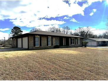 Brick ranch home with attached garage and spacious yard at 553 W Sandtown Sw Rd, Marietta, GA 30064
