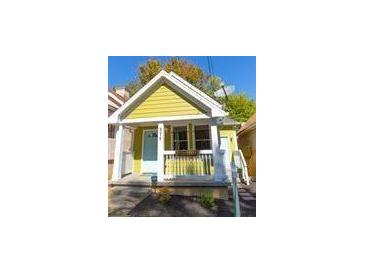 Charming yellow house with white porch and landscaping at 575 Rockwell Sw St, Atlanta, GA 30310