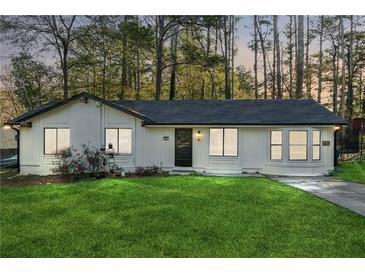 Charming ranch home with freshly painted exterior and manicured lawn at 9012 Hurst Ct, Jonesboro, GA 30238